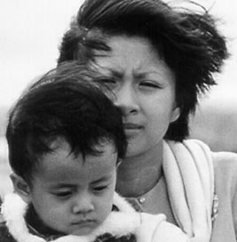 A Vietnamese refugee mother and son aboard ship
