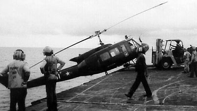 An ARVN Huey is pushed into the sea